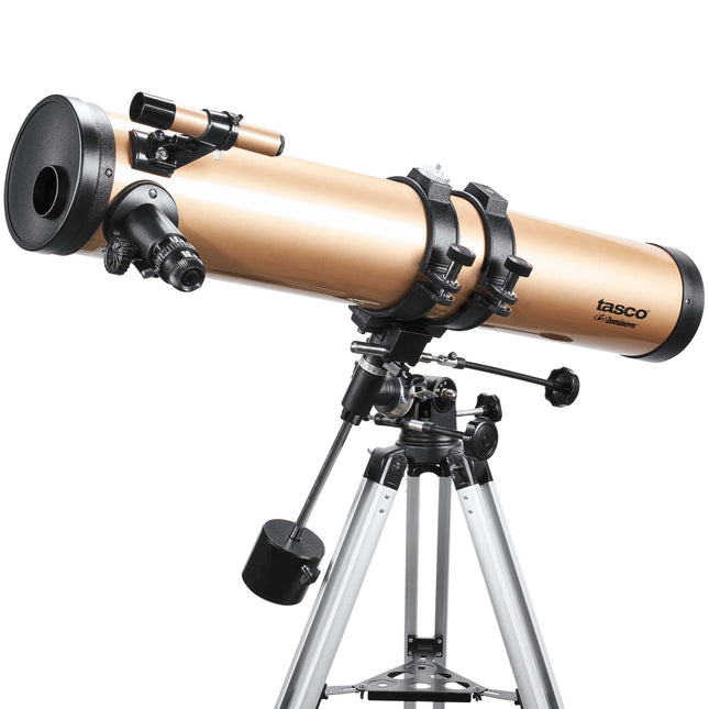 Telescopio Tasco Luminova 114×900 mm enfocado al cielo nocturno sobre trípode de aluminio, con lente grande y buscador lateral.