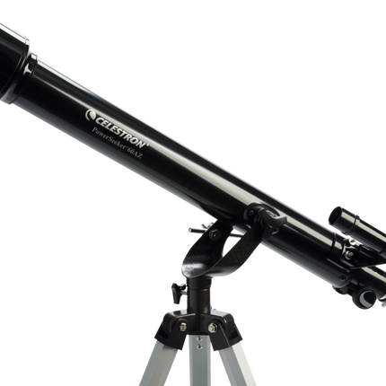 Telescopio Celestron PowerSeeker 60AZ sobre trípode de aluminio, con lente objetiva de 60 mm, buscador lateral y accesorios visibles (oculares, diagonal).