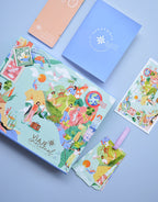 elementos Caja Kit Mi Viaje Emocional Amuratta con itinerario, tarjetas, pasaporte y postal ilustrada para gestionar emociones.