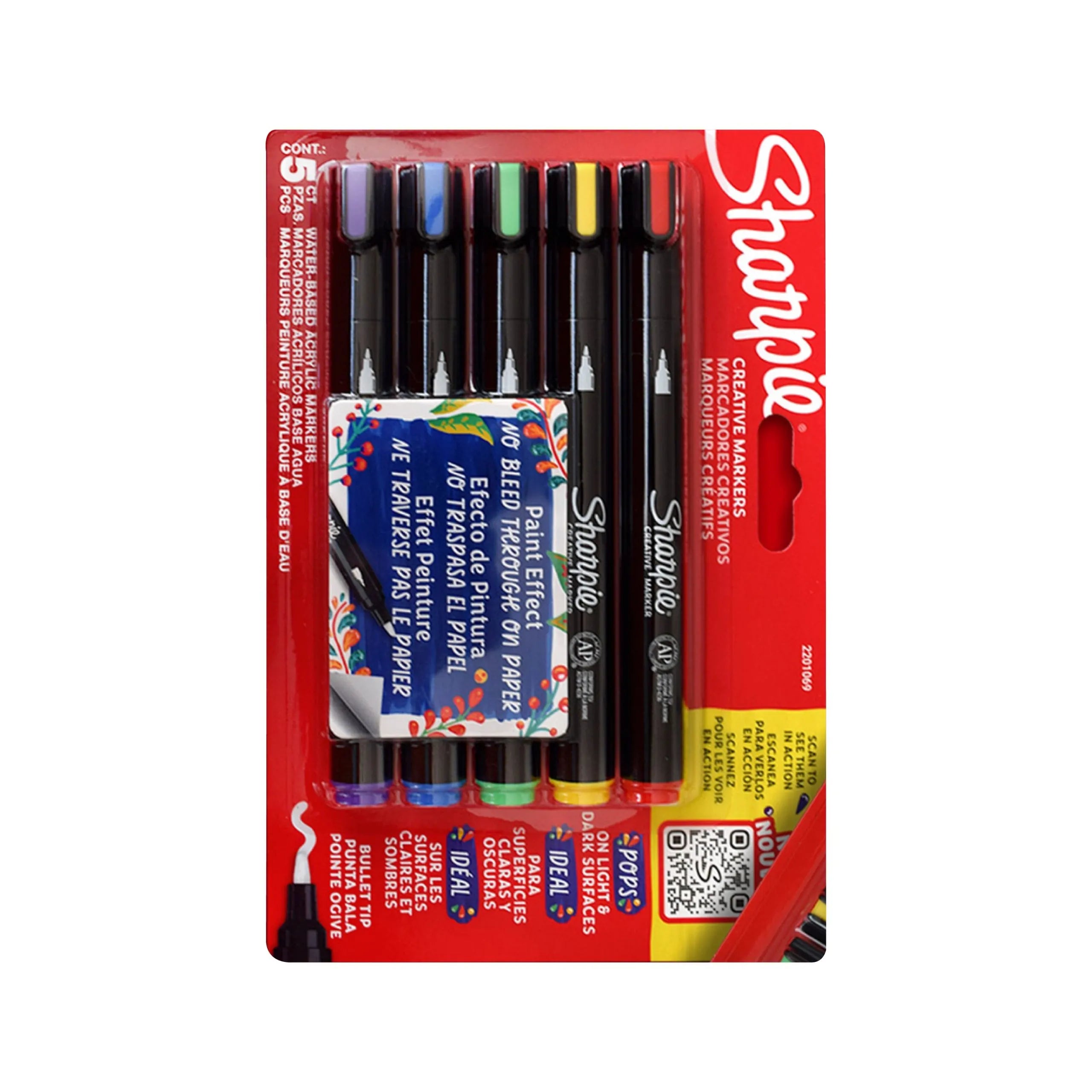 Cinco marcadores Sharpie acrílicos punta pincel en colores surtidos (rojo, amarillo, verde, azul, morado) alineados sobre fondo blanco.